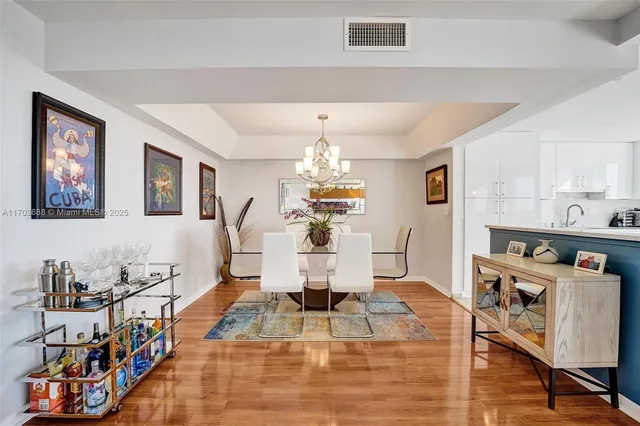 a view of a dining room with furniture wooden floor and chandelier