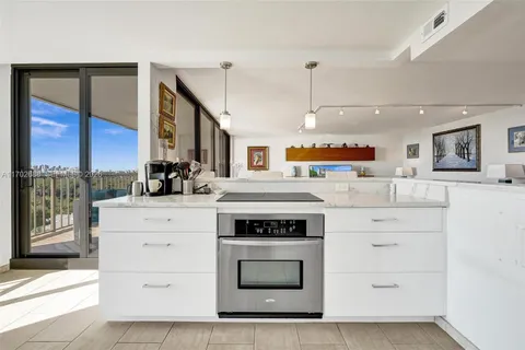 a view of a swimming pool with a lounge chair and palm trees