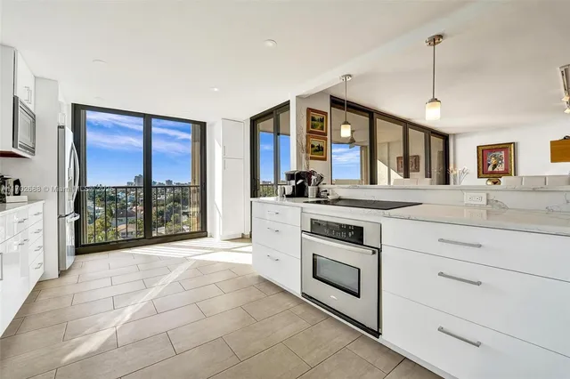 a kitchen with granite countertop a sink and cabinets