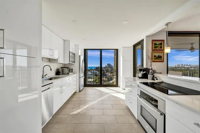 a kitchen with stainless steel appliances granite countertop a refrigerator and a sink