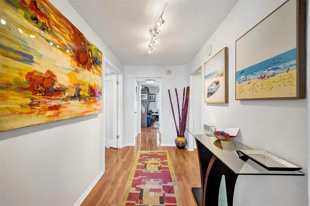 a view of a hallway view with wooden floor and staircase