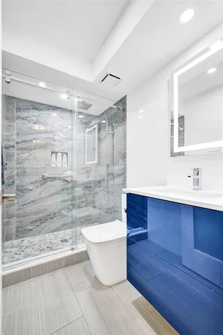 a front view of a house with a yard and potted plants