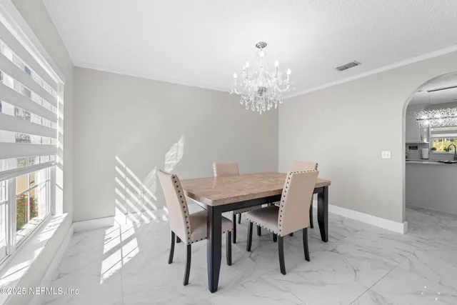 a view of a dining room with furniture and window