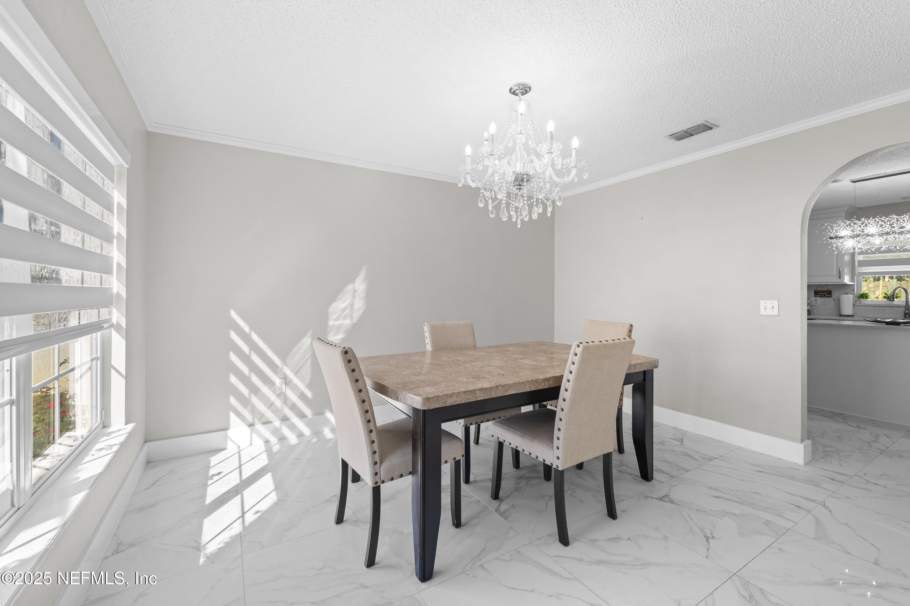 3447 Caroline Ridge Lane East Jacksonville, FL 32225 - Photo 12 of 44 a view of a dining room with furniture and chandelier