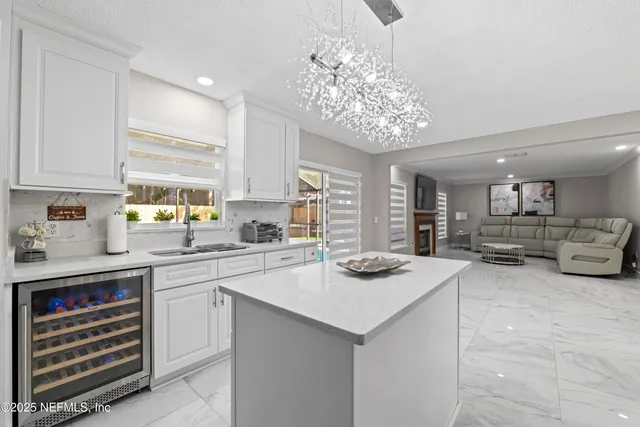 a kitchen with cabinets appliances and a window