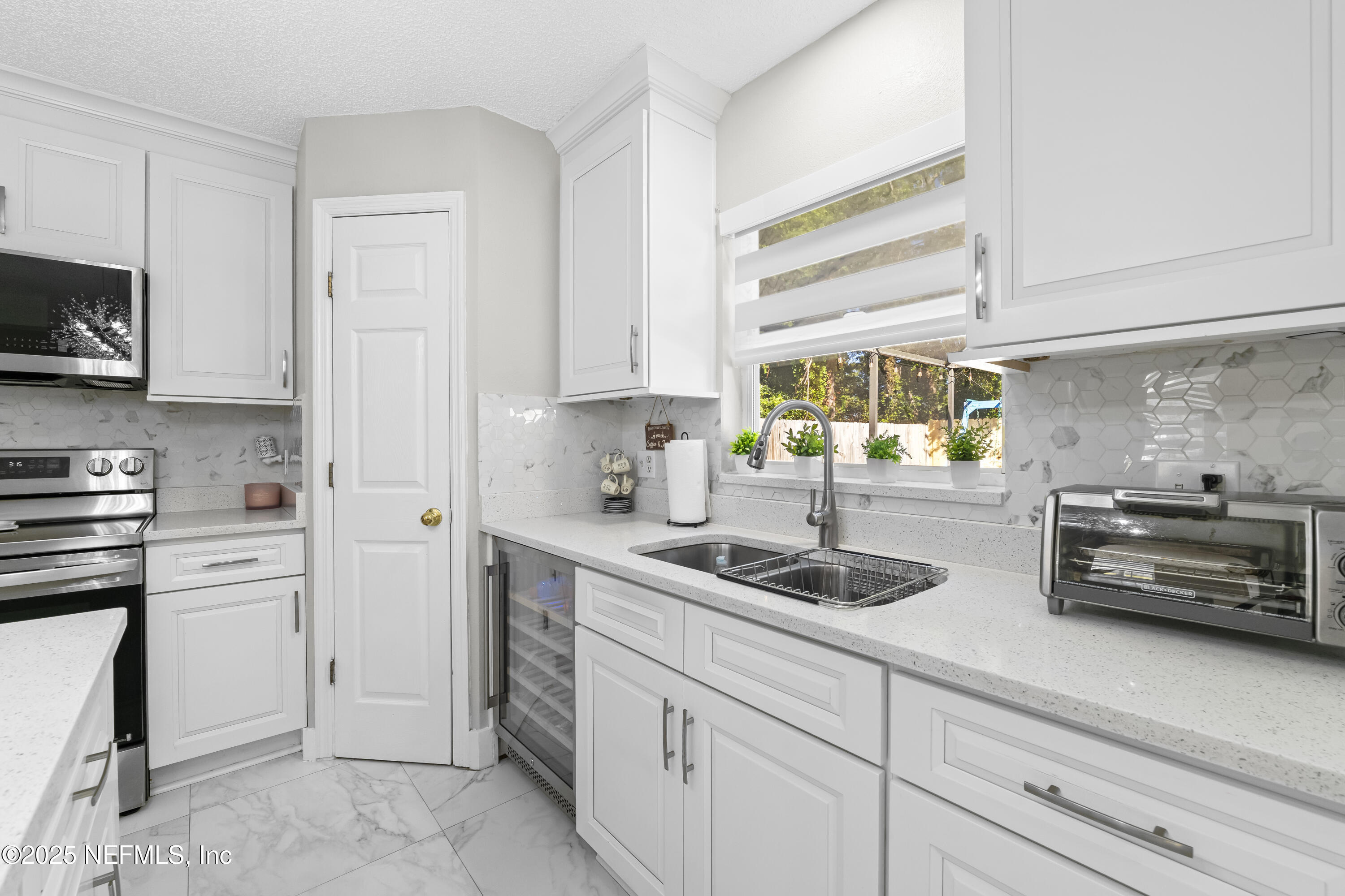 3447 Caroline Ridge Lane East Jacksonville, FL 32225 - Photo 17 of 44 a kitchen with cabinets appliances and a window