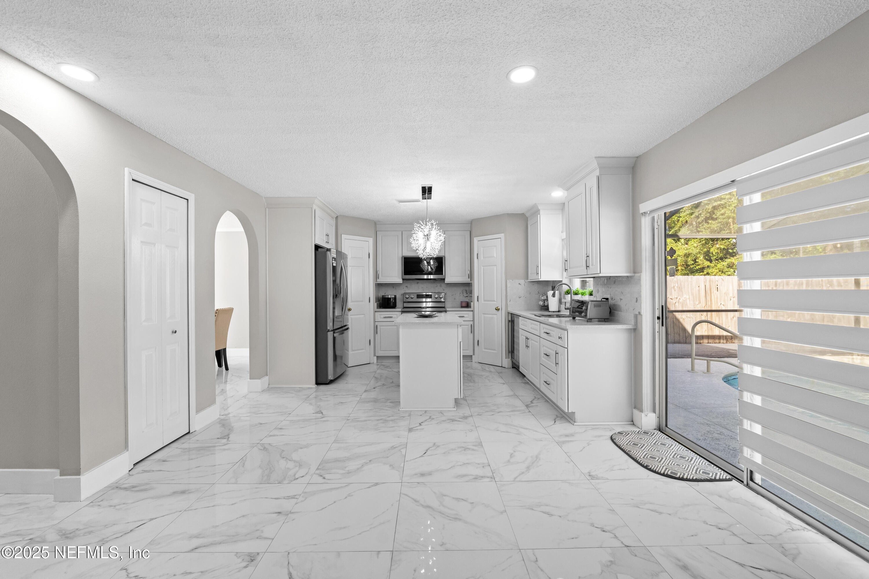 3447 Caroline Ridge Lane East Jacksonville, FL 32225 - Photo 19 of 44 a kitchen with white cabinets and stainless steel appliances