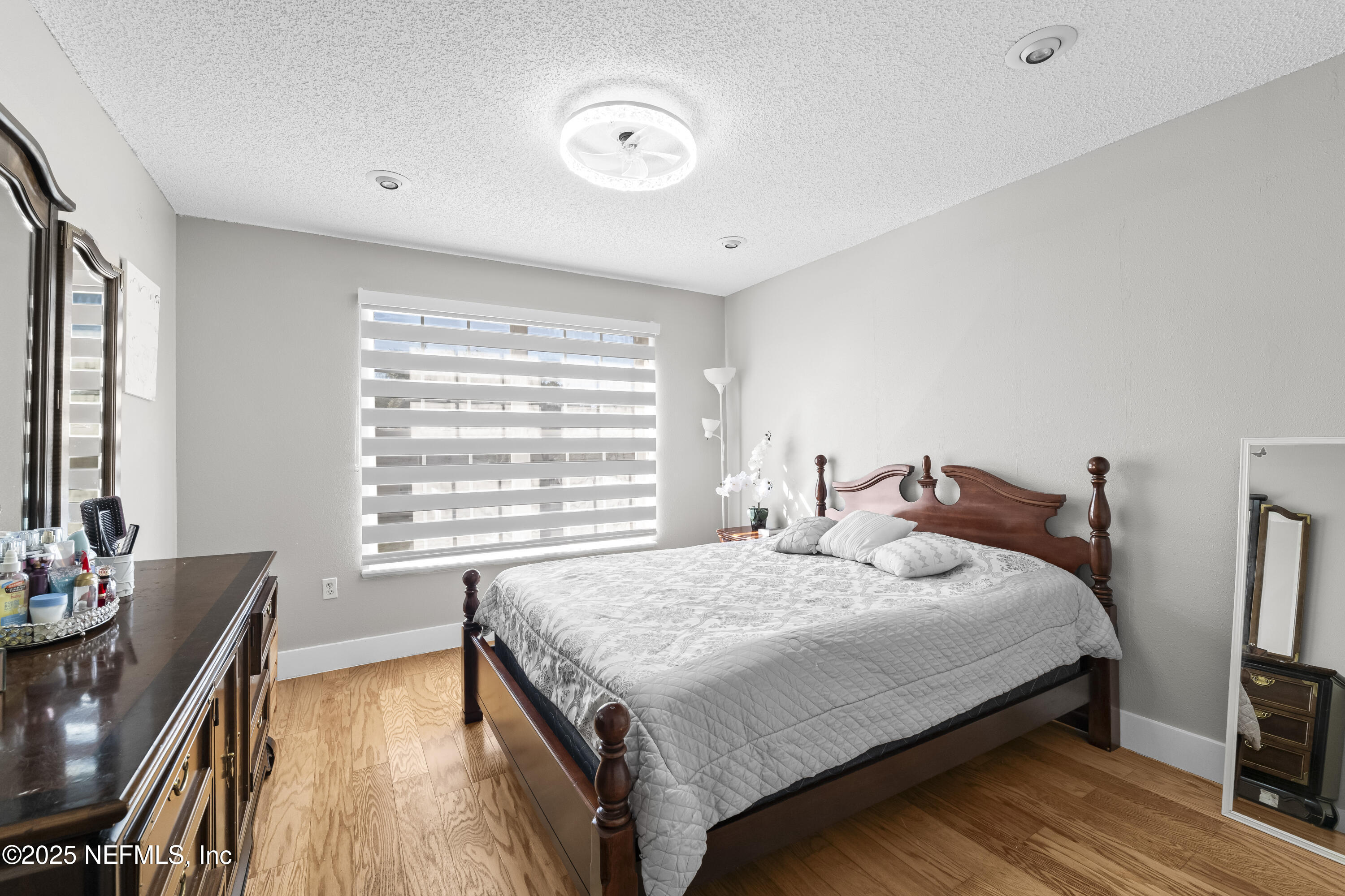 3447 Caroline Ridge Lane East Jacksonville, FL 32225 - Photo 23 of 44 a bedroom with a bed and wooden floor