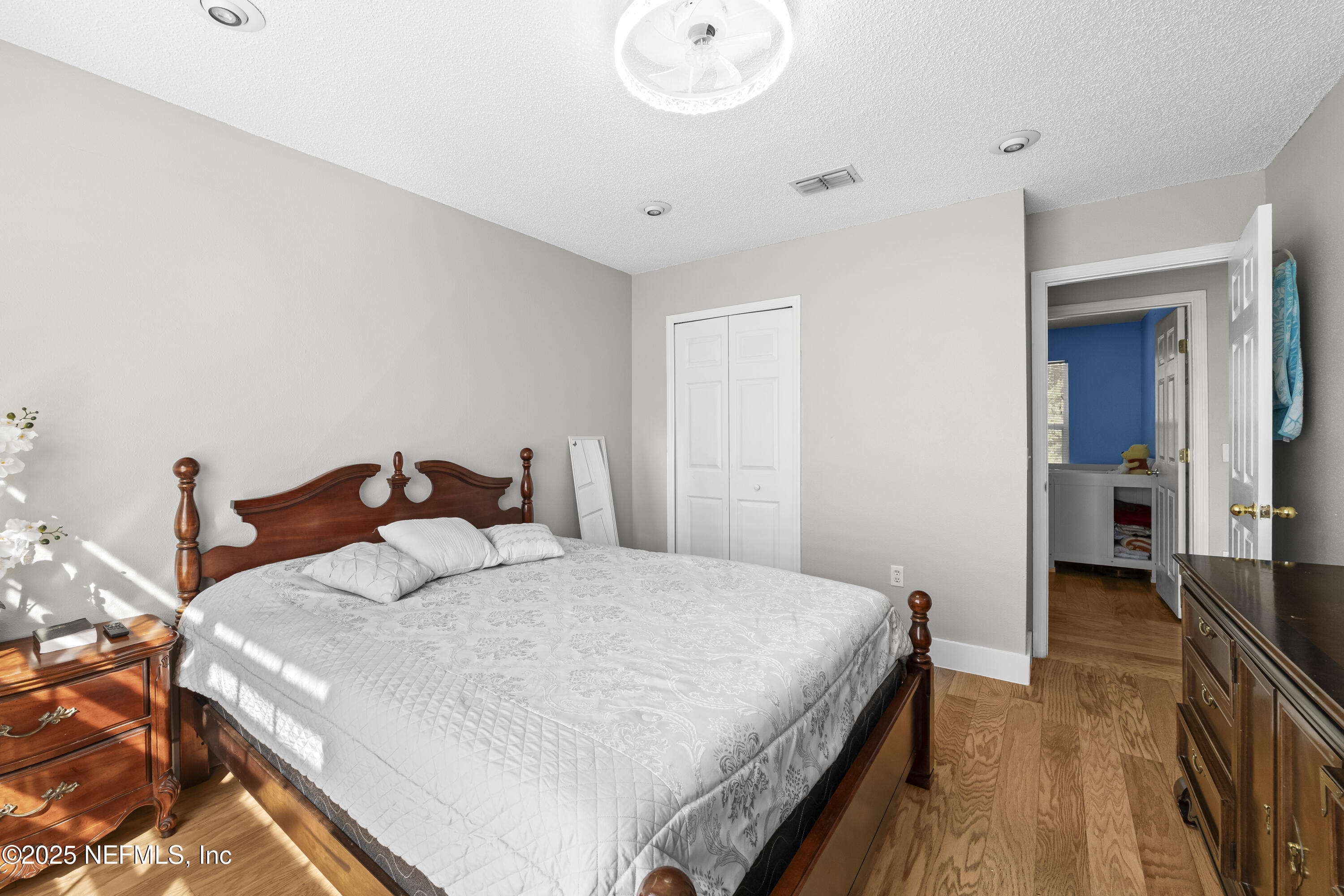 3447 Caroline Ridge Lane East Jacksonville, FL 32225 - Photo 24 of 44 a bedroom with a bed and a chandelier