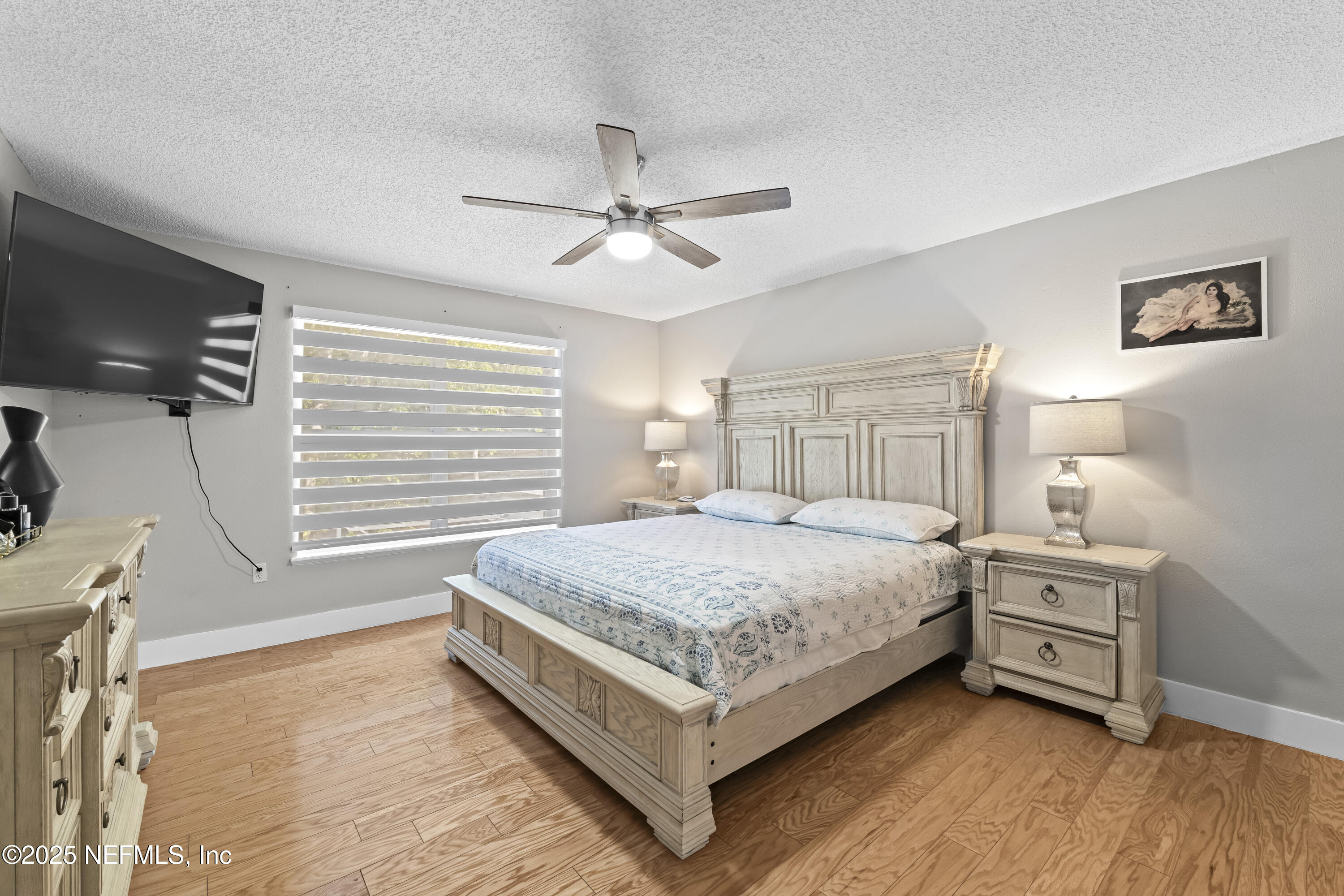 3447 Caroline Ridge Lane East Jacksonville, FL 32225 - Photo 27 of 44 a spacious bedroom with a bed and a flat screen tv