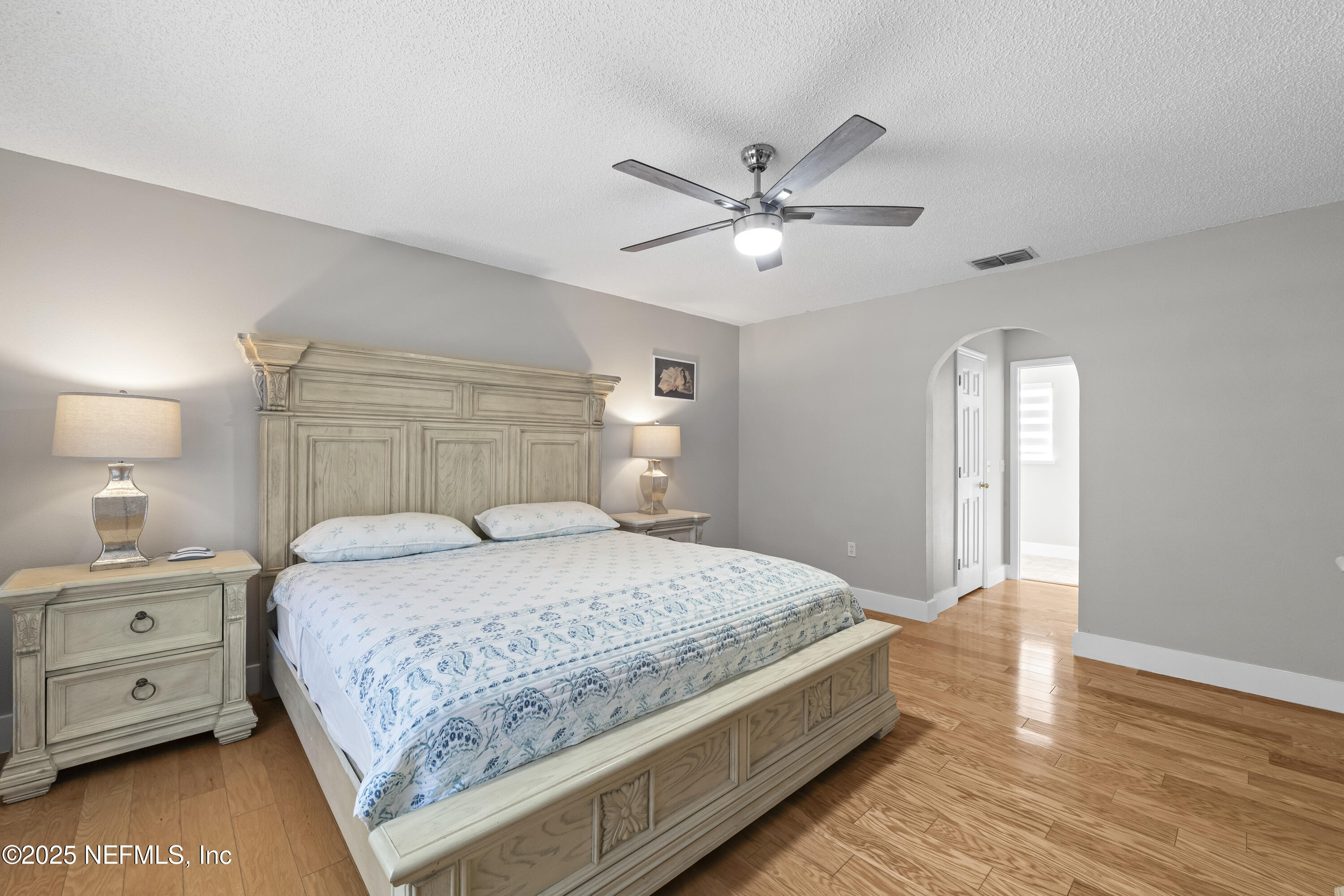 3447 Caroline Ridge Lane East Jacksonville, FL 32225 - Photo 28 of 44 a bedroom with a large bed and a chandelier