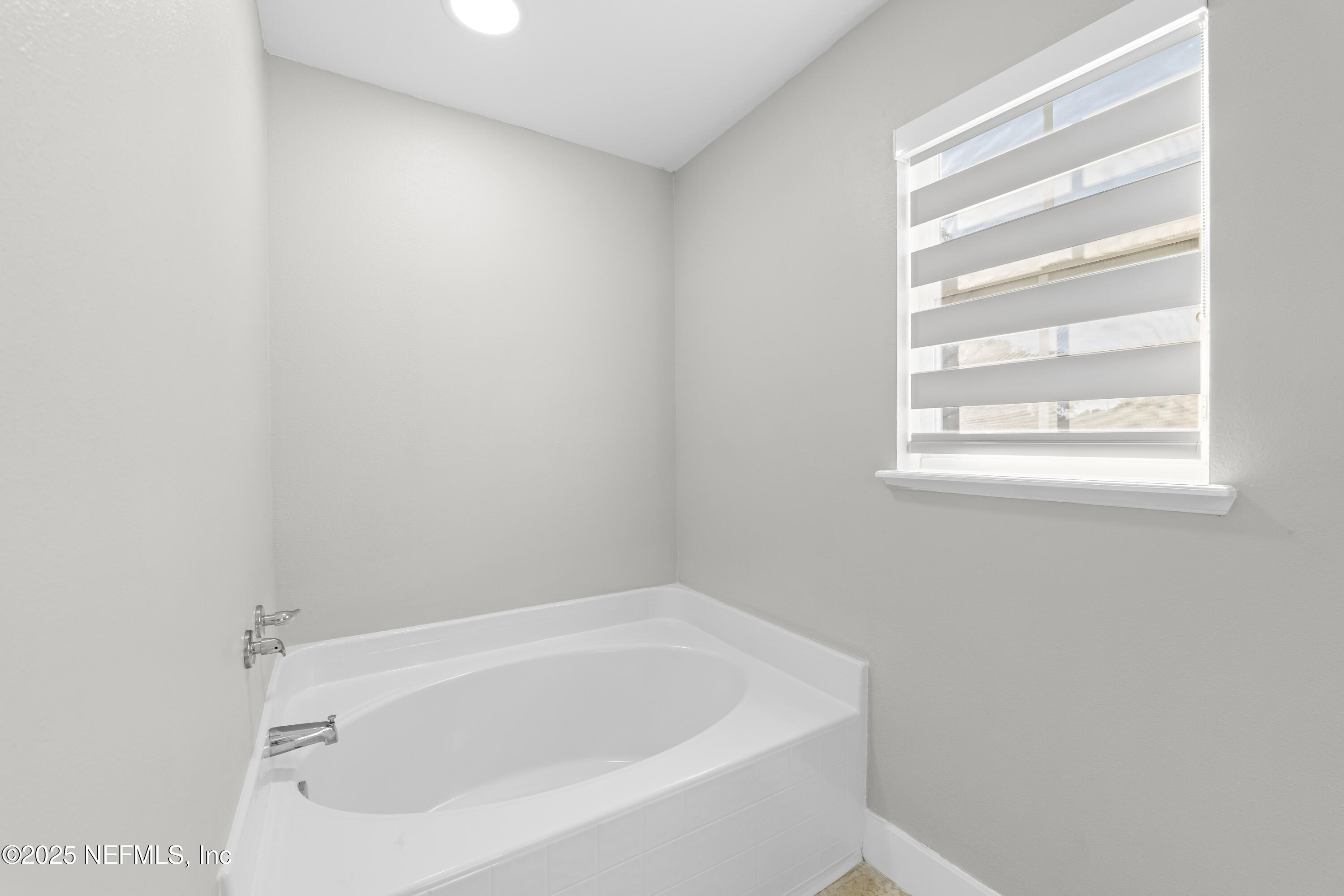 3447 Caroline Ridge Lane East Jacksonville, FL 32225 - Photo 30 of 44 a white bath tub sitting next to a window