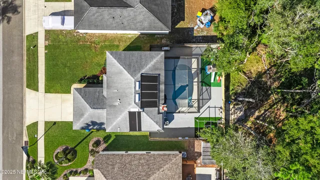 an aerial view of a house with garden space and street view