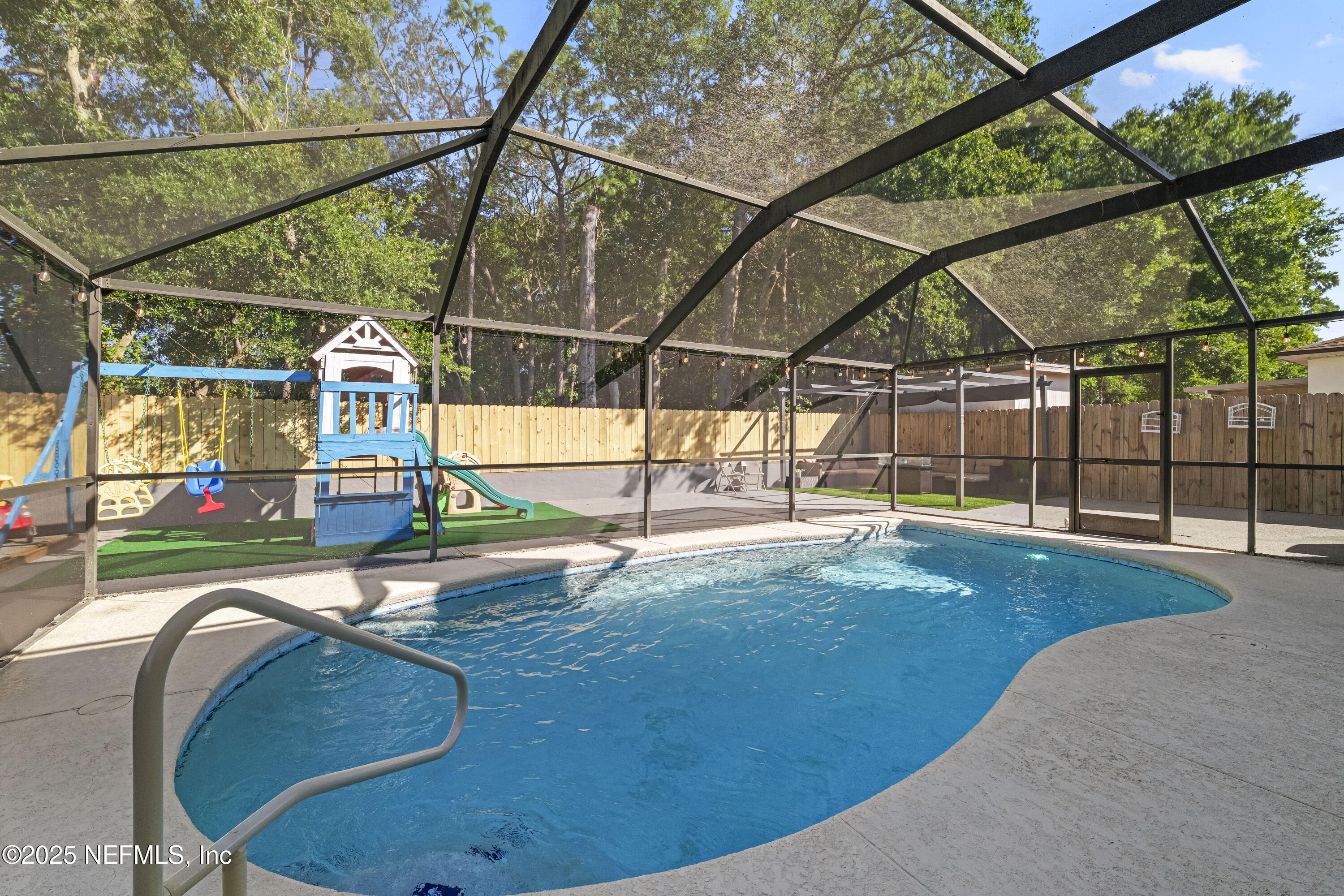 3447 Caroline Ridge Lane East Jacksonville, FL 32225 - Photo 33 of 44 a view of a swimming pool with a porch and furniture