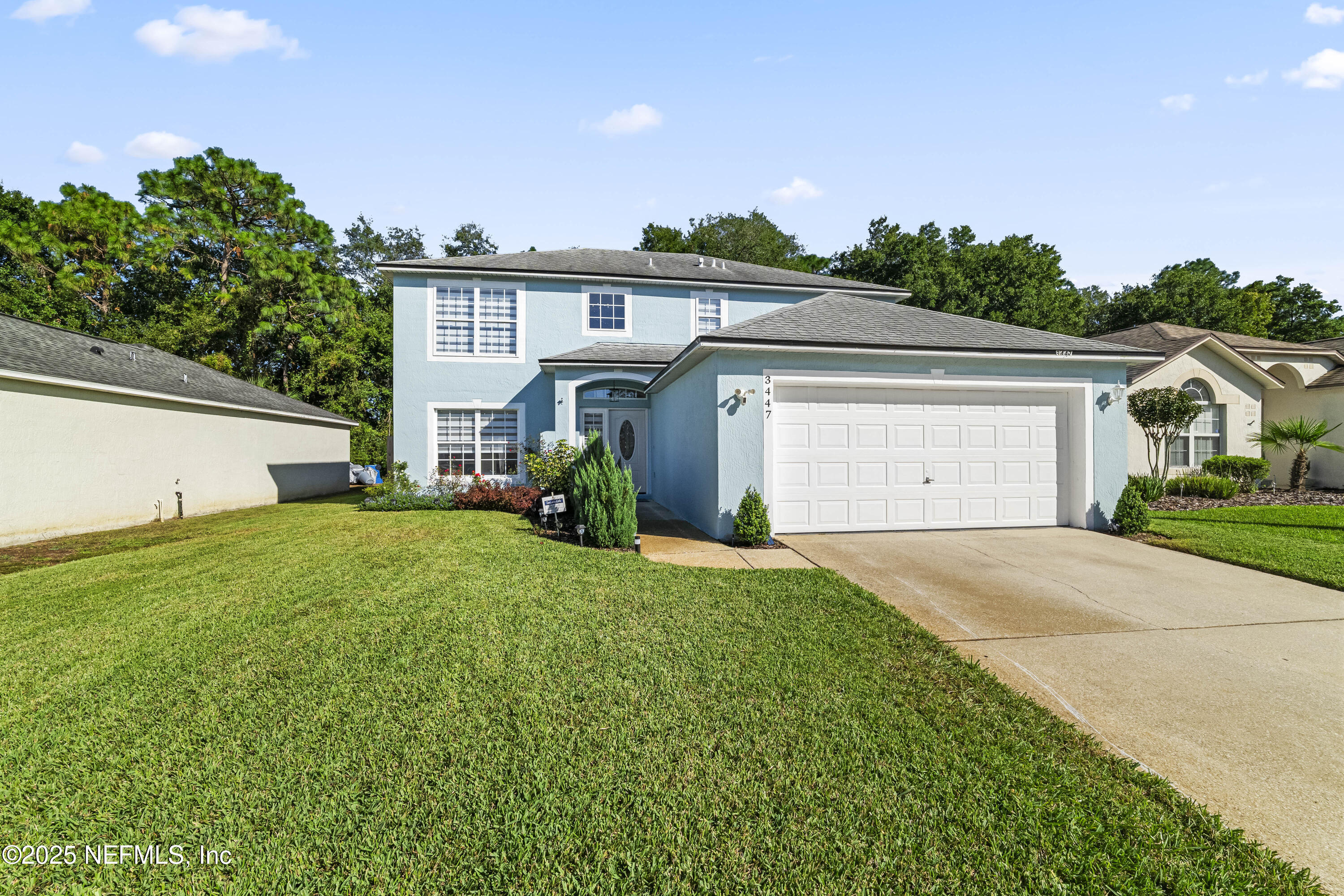 3447 Caroline Ridge Lane East Jacksonville, FL 32225 - Photo 42 of 44 a front view of a house with a yard and garage