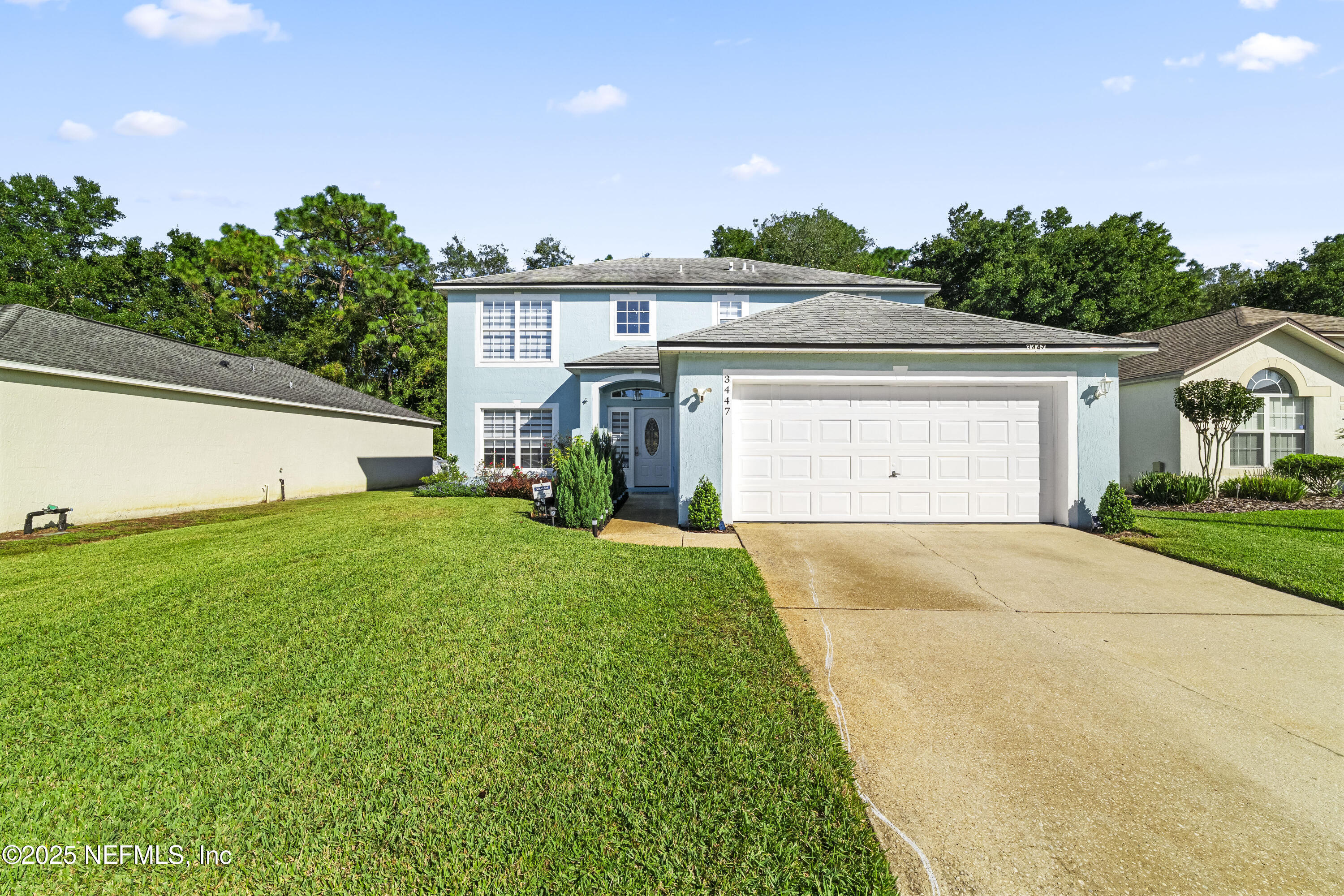 3447 Caroline Ridge Lane East Jacksonville, FL 32225 - Photo 43 of 44 a front view of a house with a yard and garage