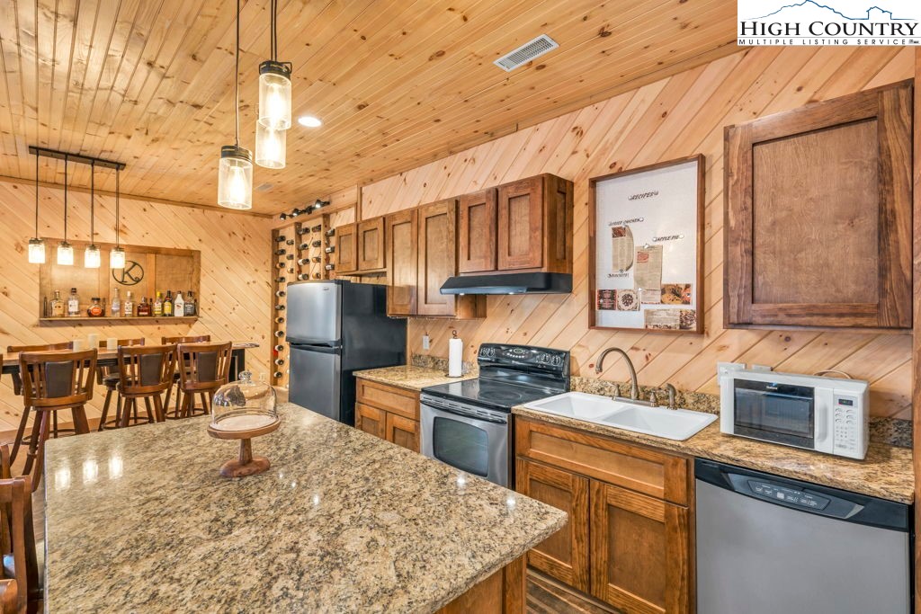 173 Spring Brook Road Newland, NC 28657 - Photo 28 of 39 a kitchen with stainless steel appliances granite countertop a sink stove and refrigerator