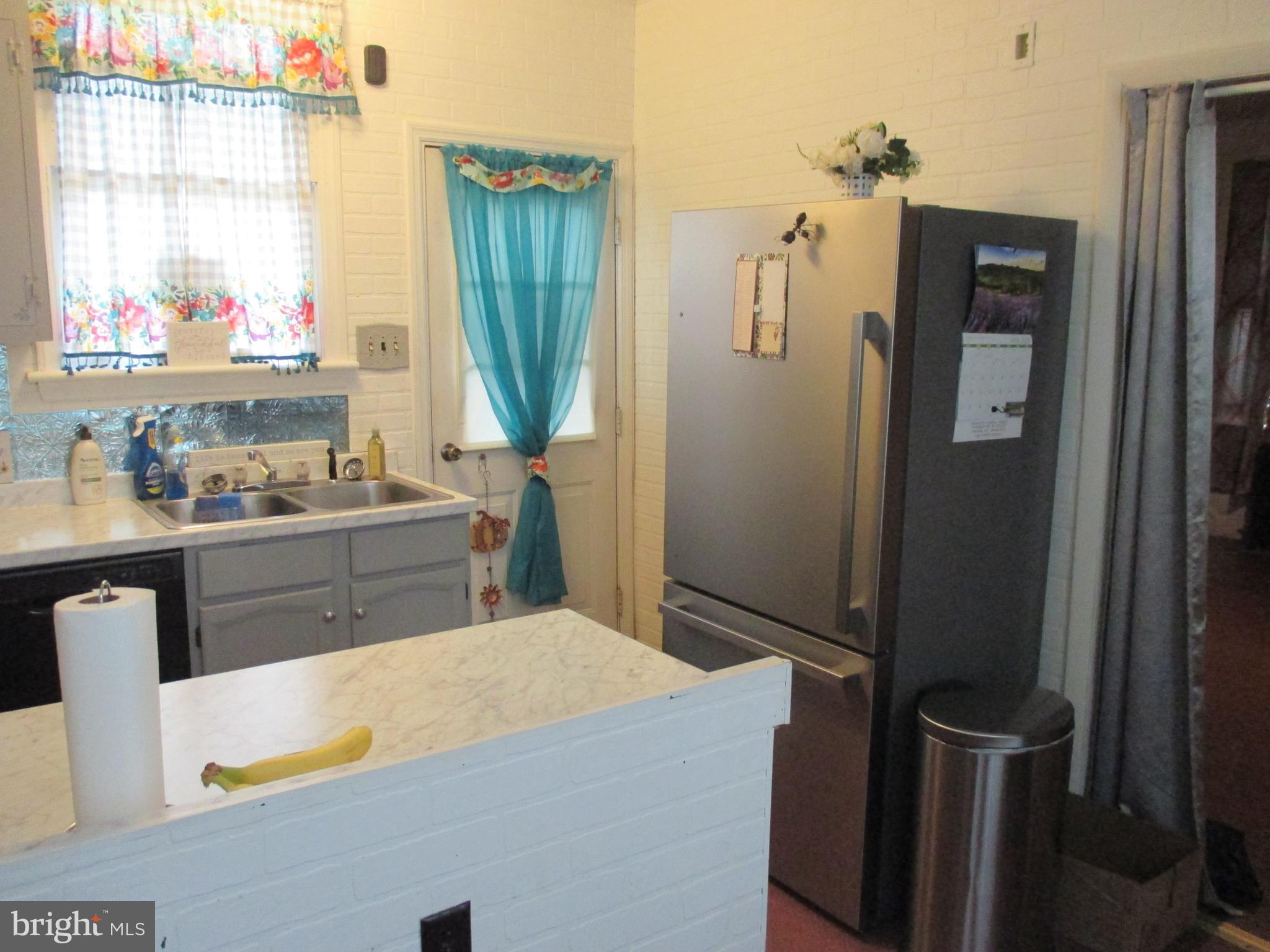 333 Pratt Street Luke, MD 21540 - Photo 4 of 42 a kitchen with a sink a refrigerator and window