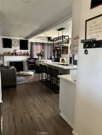 a kitchen with kitchen island a white counter top space a stove and cabinets