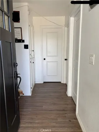 a view of a hallway with wooden floor and staircase