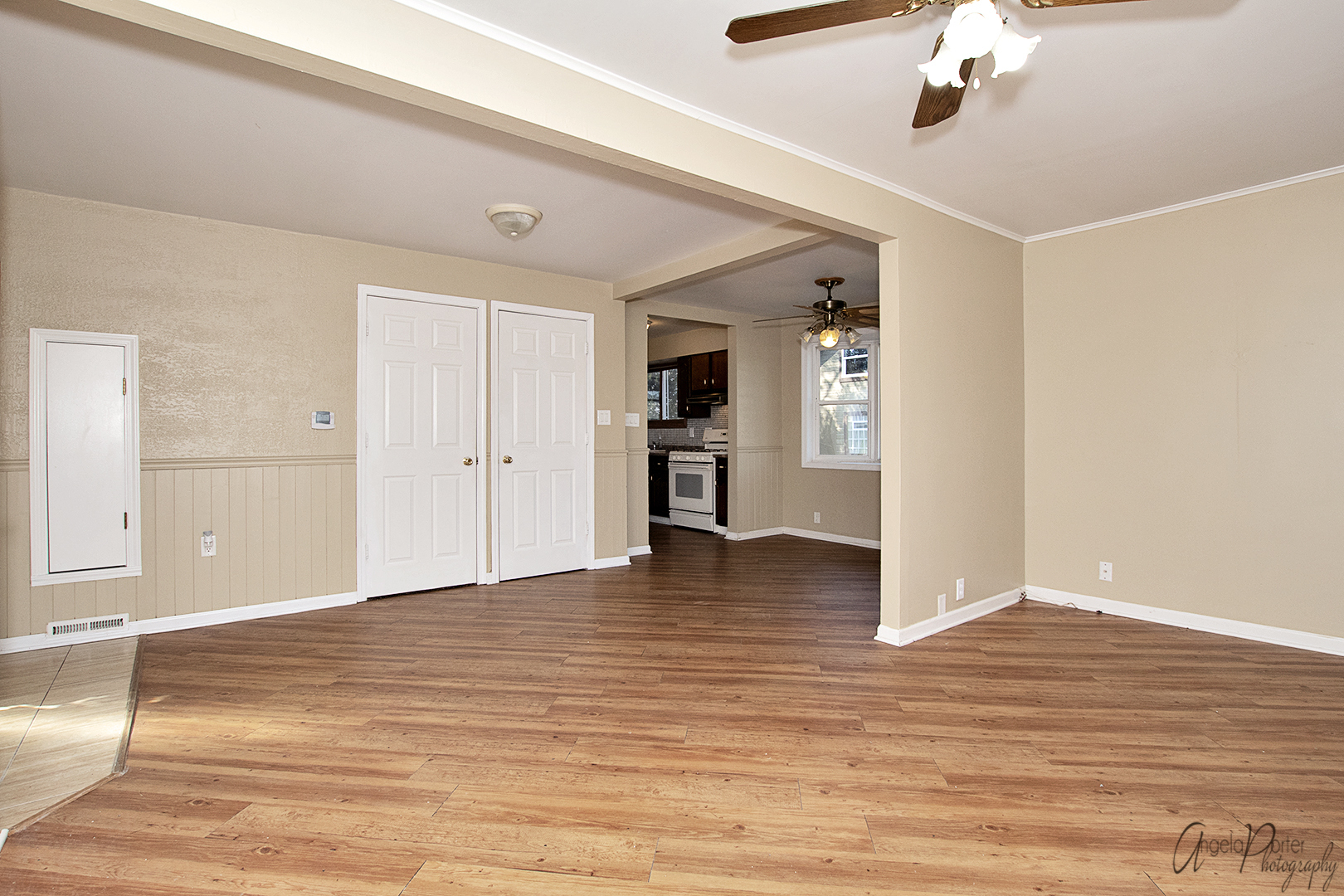 28537 West Treetop Road Ingleside, IL 60041 - Photo 6 of 29 an empty room with wooden floor and way to kitchen