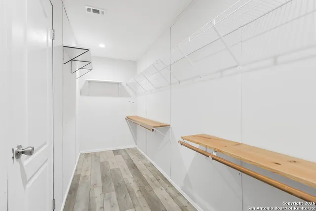 a view of a room with wooden floor