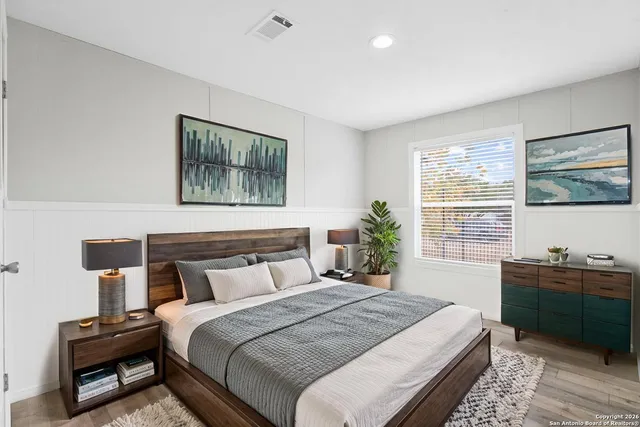 a bedroom with a bed and a window