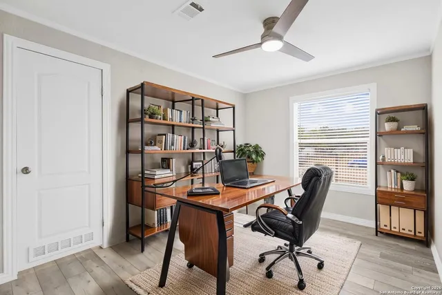 a view of a workspace with furniture and a bookshelf