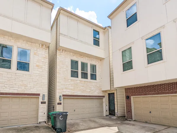 a front view of a house with garage