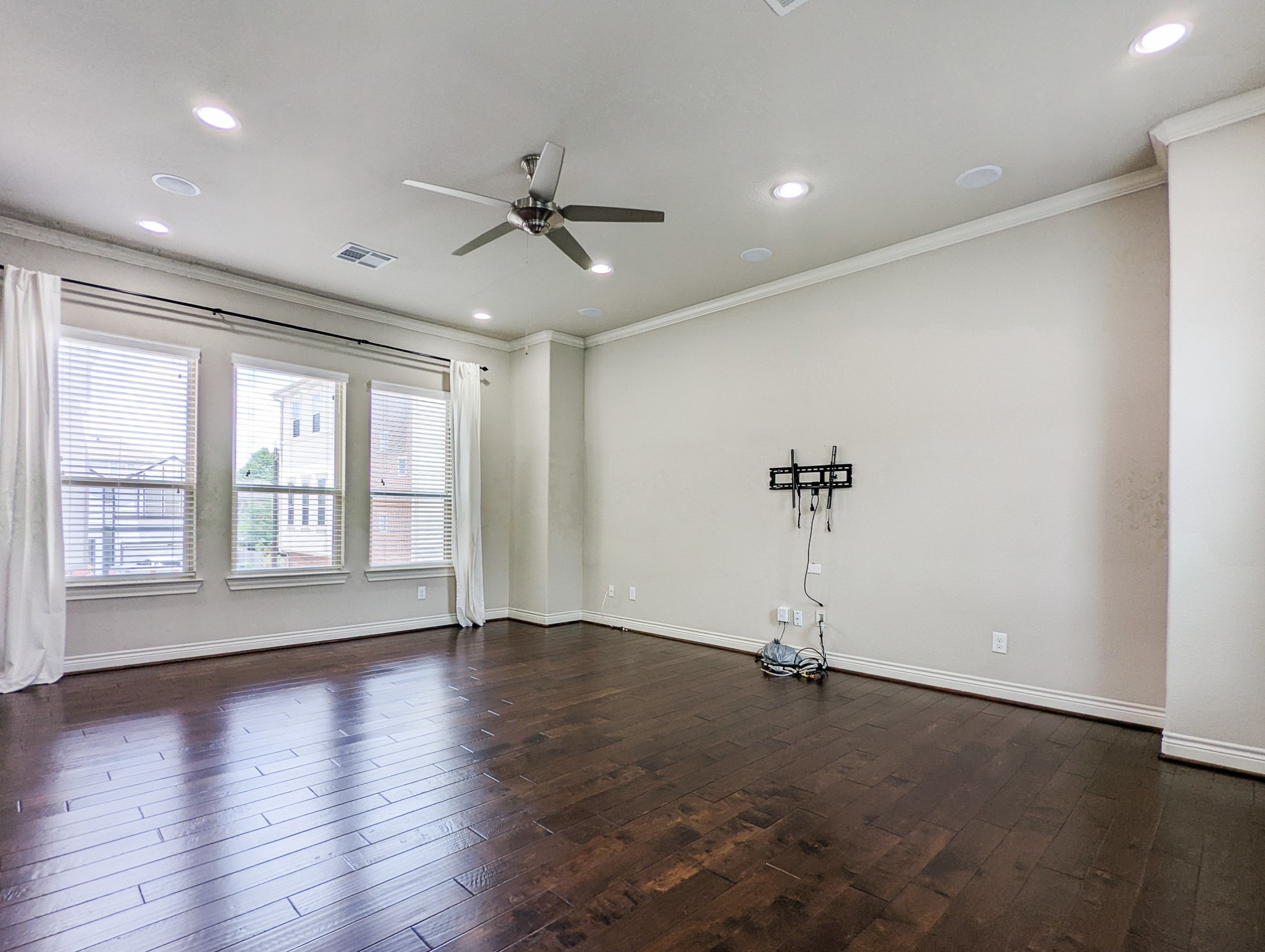 5323 Kiam Street Houston, TX 77007 - Photo 13 of 28 a view of a livingroom with a ceiling fan and wooden floor