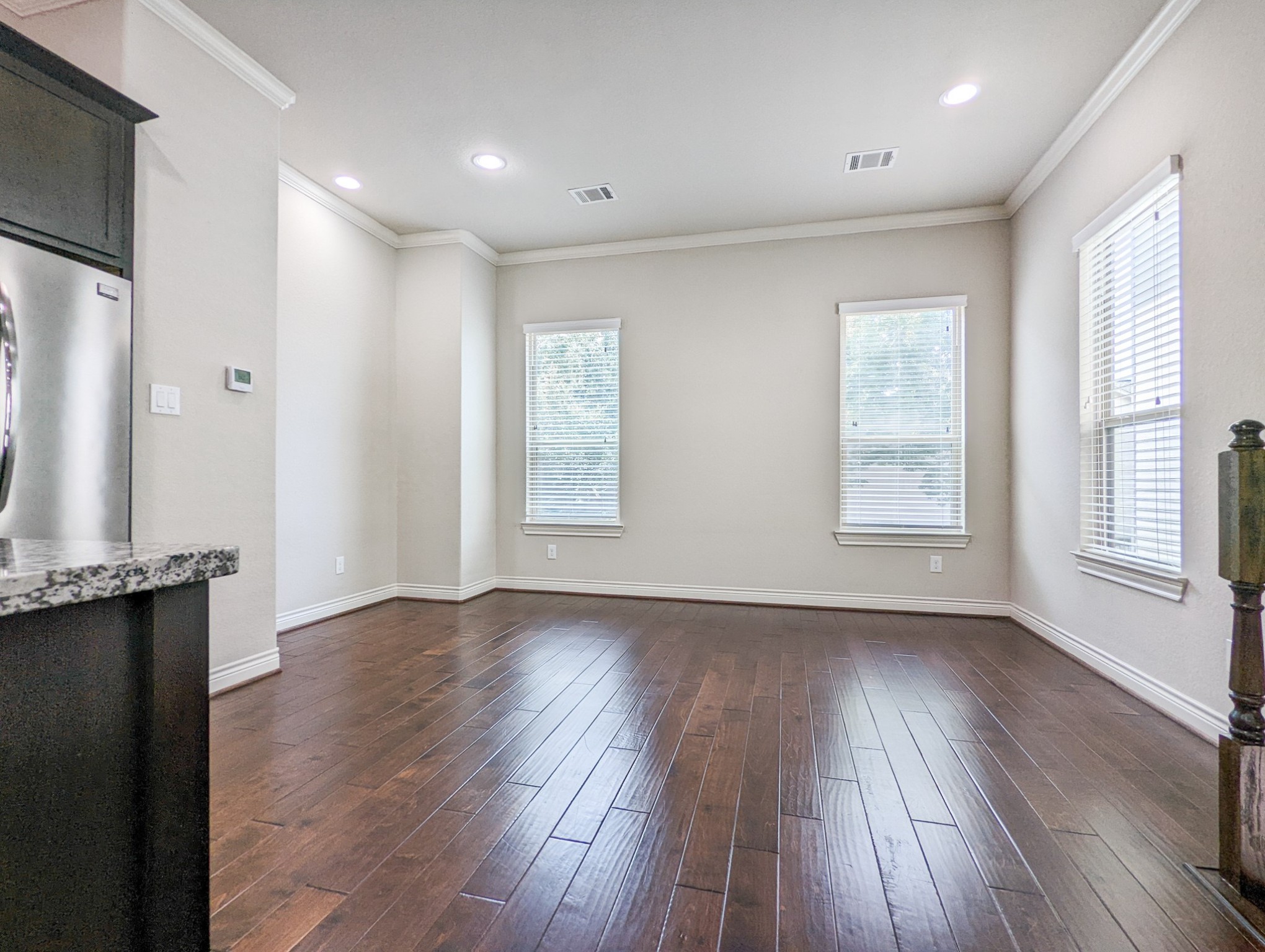 5323 Kiam Street Houston, TX 77007 - Photo 15 of 28 an empty room with wooden floor and windows
