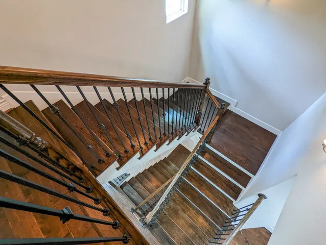 an empty room with a ceiling fan and a window