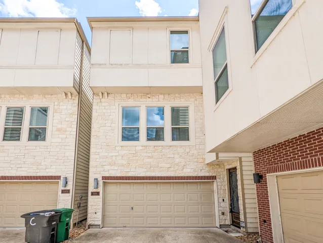 a front view of a house with garage