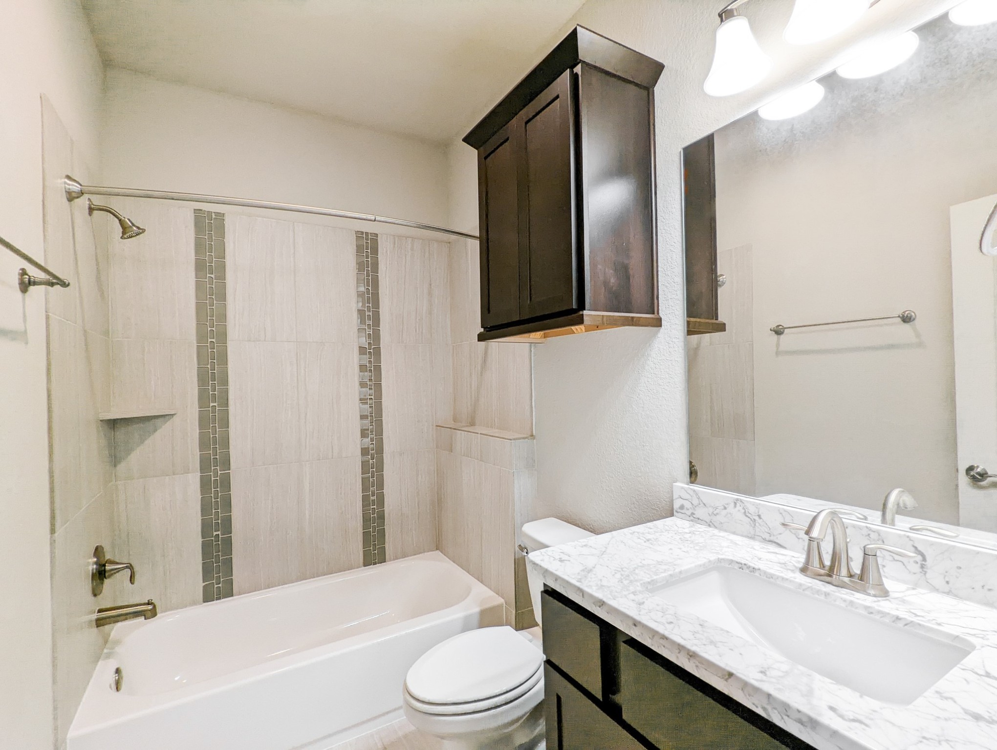5323 Kiam Street Houston, TX 77007 - Photo 25 of 28 a bathroom with a granite countertop sink toilet a mirror and shower