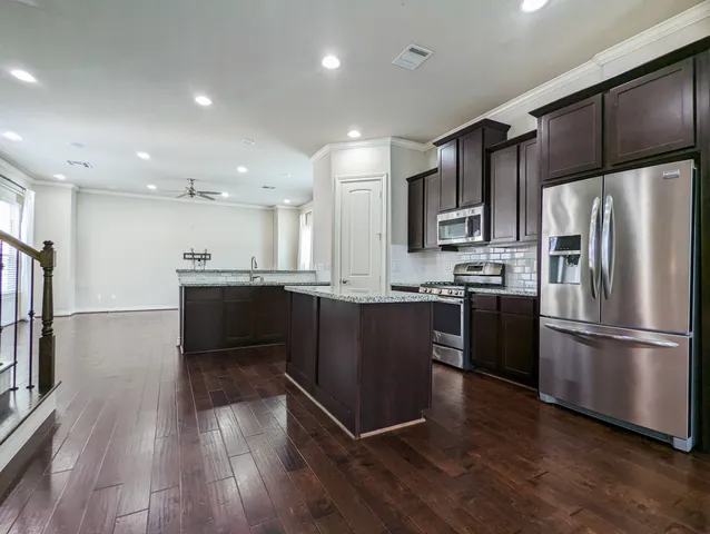 a kitchen with a refrigerator and a sink