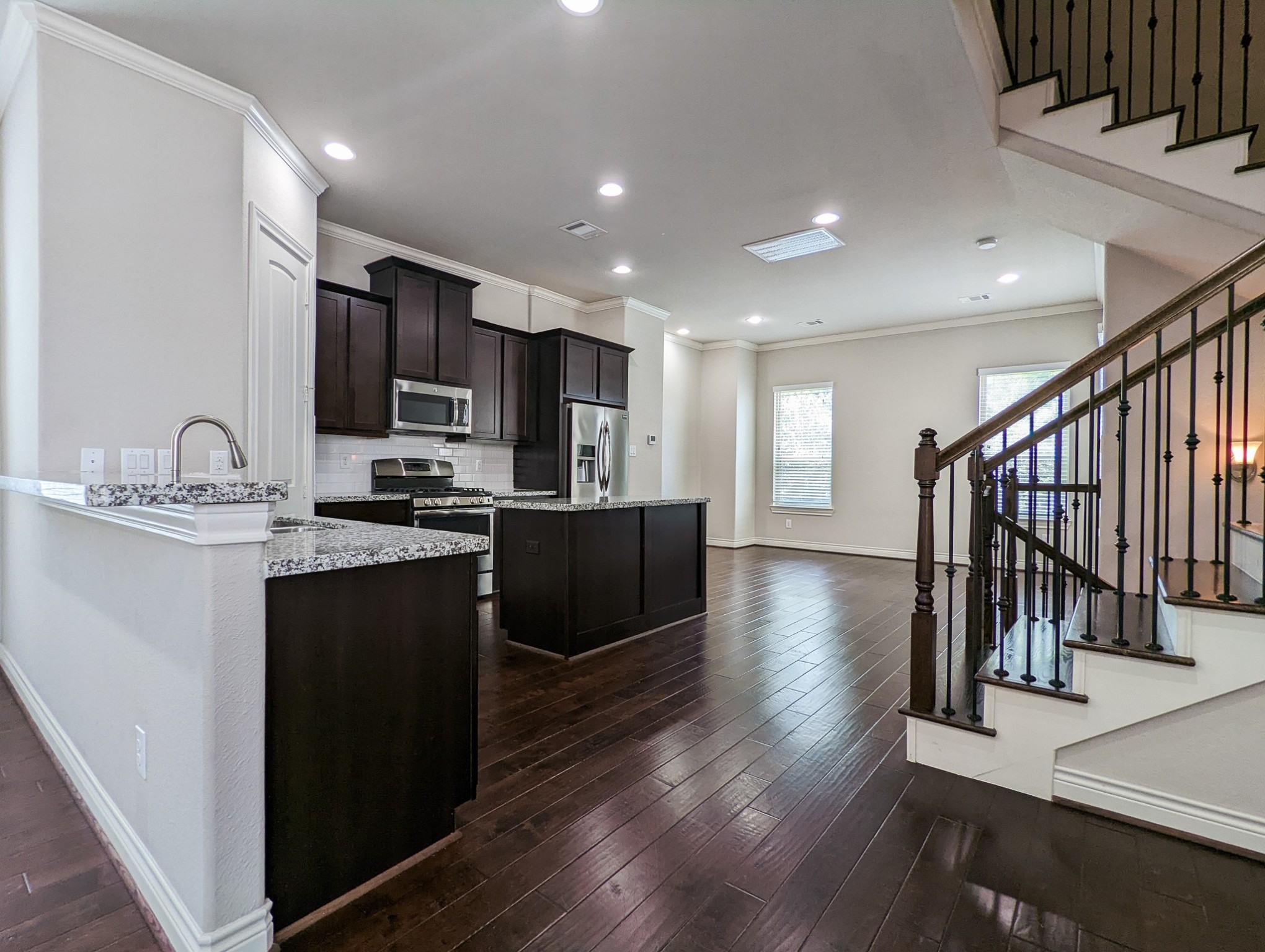 5323 Kiam Street Houston, TX 77007 - Photo 8 of 28 a kitchen with stainless steel appliances granite countertop a refrigerator a sink dishwasher a stove and a microwave oven on the wooden floor