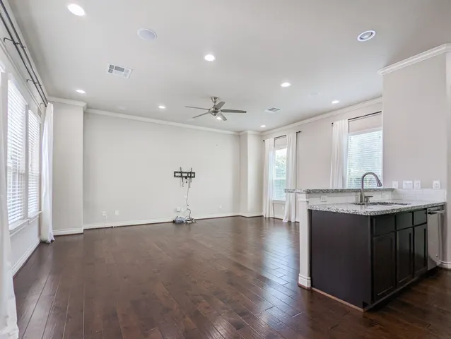 a view of a big room with wooden floor windows and chandelier