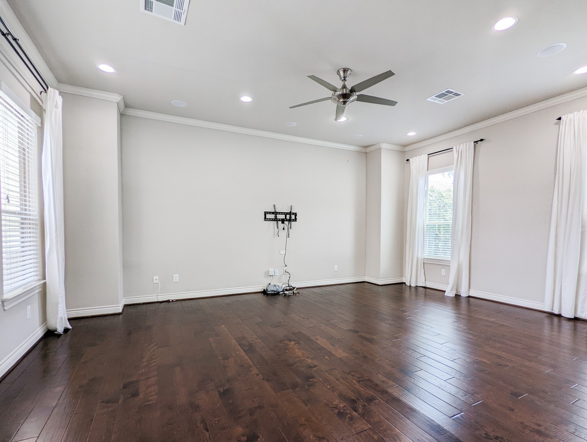 5323 Kiam Street Houston, TX 77007 - Photo 10 of 28 an empty room with wooden floor a ceiling fan and windows