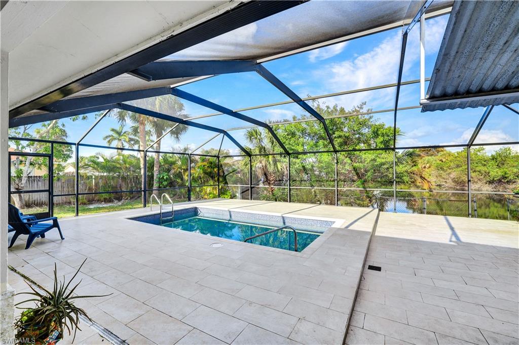 a view of swimming pool with seating area and car parked