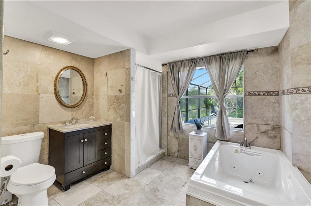 2540 47th Terrace Southwest Naples, FL 34116 - Photo 11 of 17 a bathroom with a sink toilet and tub