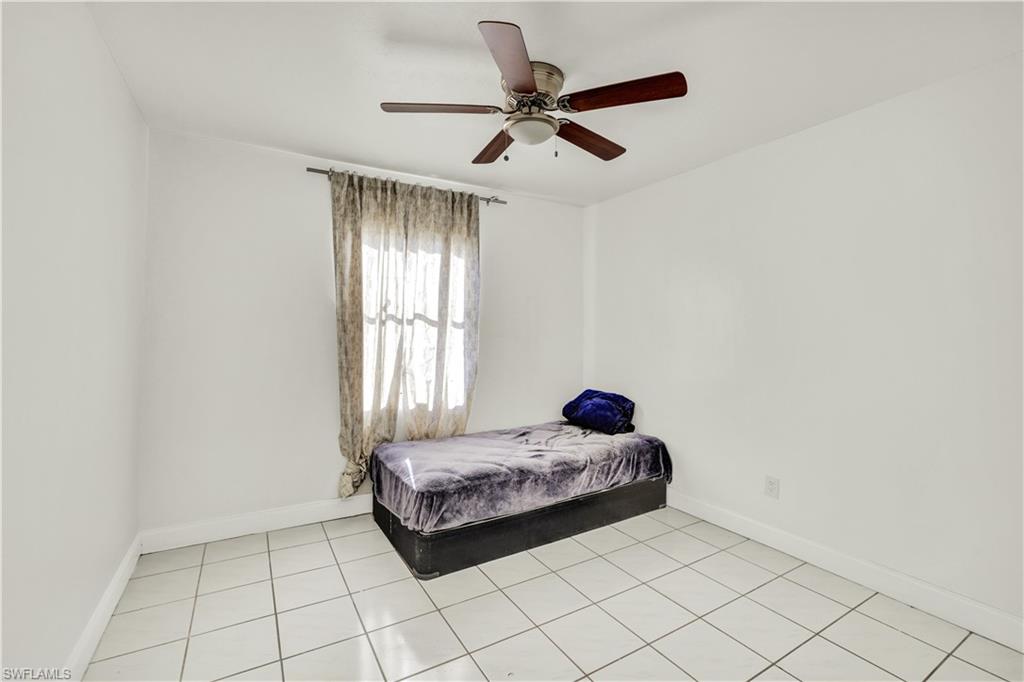 2540 47th Terrace Southwest Naples, FL 34116 - Photo 12 of 17 a room with a bed and a window
