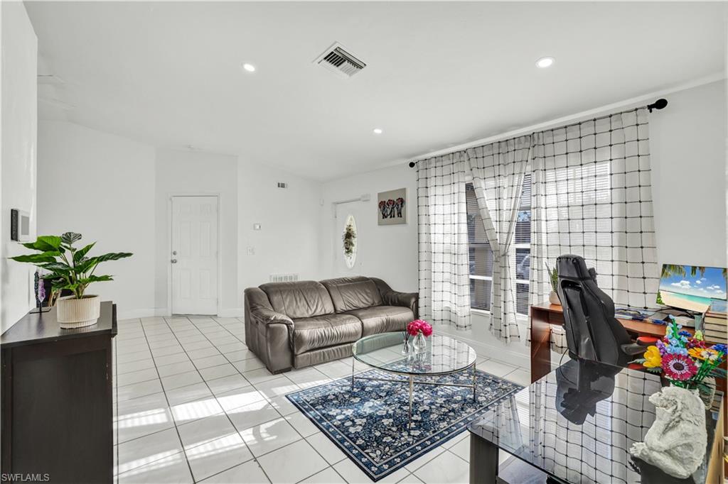 2540 47th Terrace Southwest Naples, FL 34116 - Photo 5 of 17 a living room with furniture floor and a table