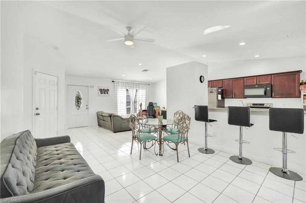 2540 47th Terrace Southwest Naples, FL 34116 - Photo 7 of 17 a living room with furniture and a view of kitchen