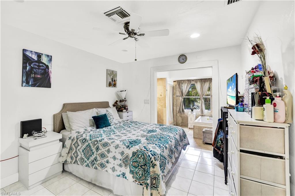 2540 47th Terrace Southwest Naples, FL 34116 - Photo 10 of 17 a bed room with a bed and a refrigerator