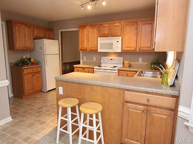 2617 Salisbury Raleigh, NC 27613 - Photo 5 of 11 a kitchen with stainless steel appliances granite countertop a refrigerator sink and cabinets