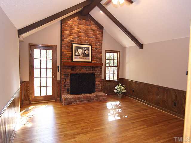 2617 Salisbury Raleigh, NC 27613 - Photo 7 of 11 a view of empty room with fireplace and wooden floor