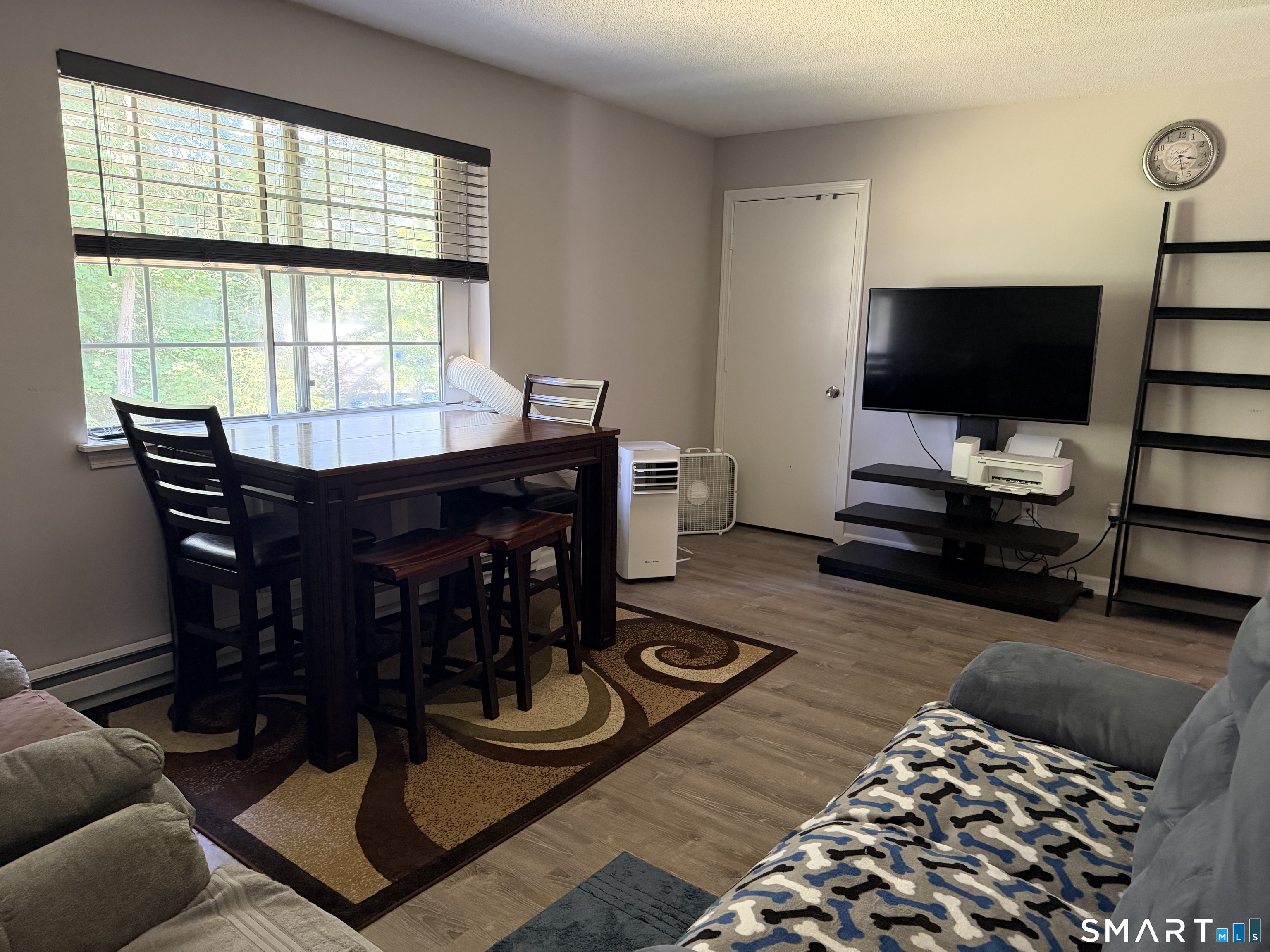21 Lisa Court, Unit 10 Waterbury, CT 06704 - Photo 7 of 14 a living room with furniture and a flat screen tv