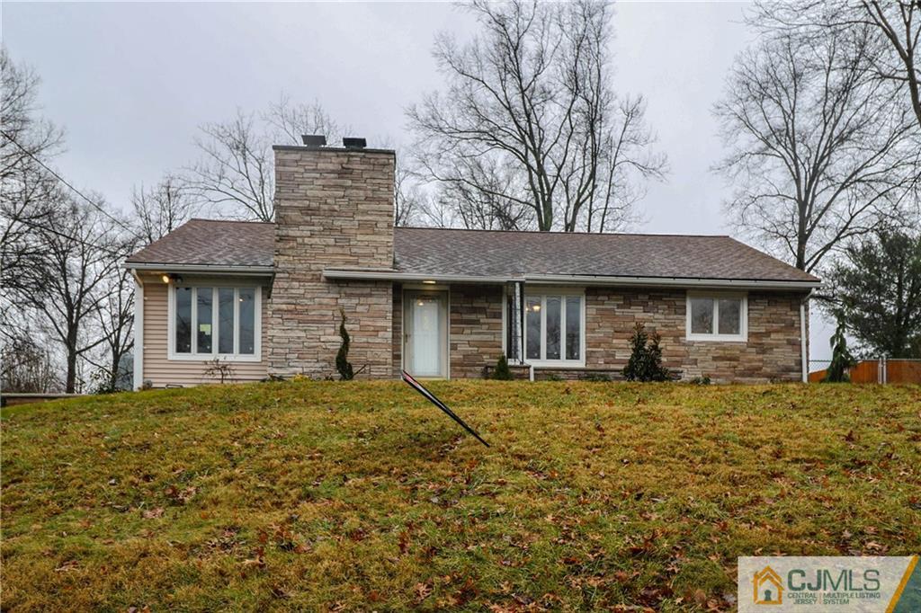 355 Chain O' Hills Road Colonia, NJ 07067 - Photo 1 of 25 a front view of a house with garden