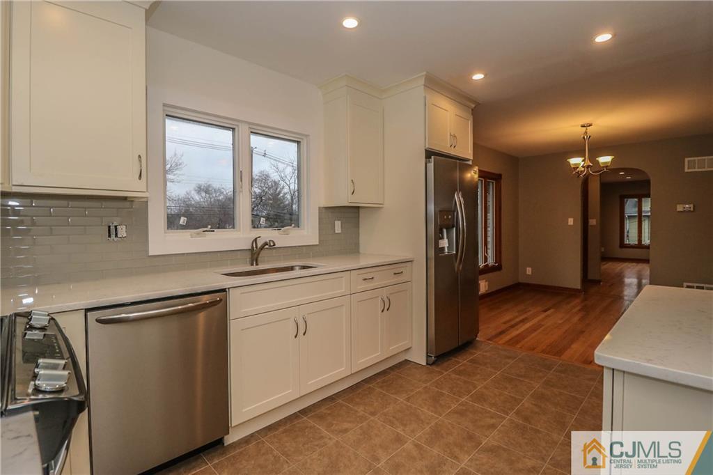 355 Chain O' Hills Road Colonia, NJ 07067 - Photo 13 of 25 a kitchen with stainless steel appliances granite countertop a refrigerator and a sink