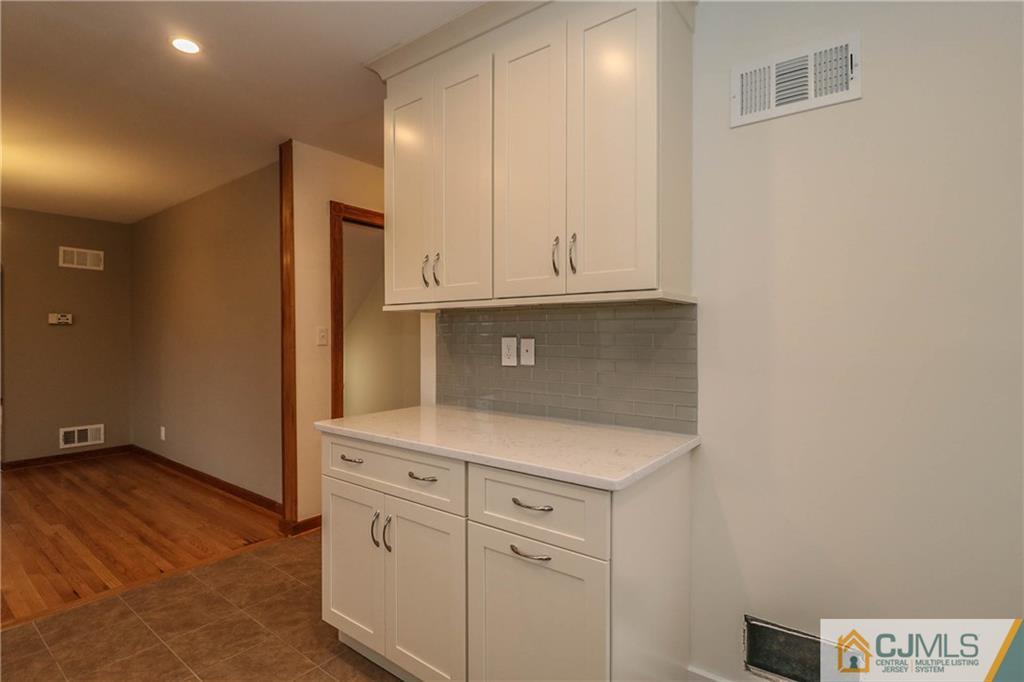 355 Chain O' Hills Road Colonia, NJ 07067 - Photo 14 of 25 a view of cabinets with wooden floor